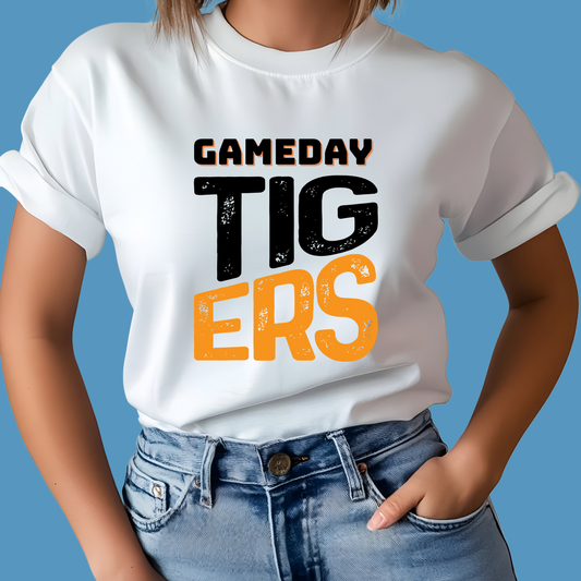 Person wearing a white t-shirt with 'GAMEDAY TIGERS' text on a blue background Custom Mascot Shirt - Game Day Tigers - School Spirit Tee Shirt