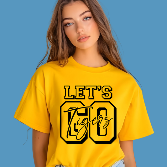 Woman wearing a yellow t-shirt with 'LET'S GO Tigers' text on a blue background, Custom Mascot Shirt - Let's Go Tigers Game Day Spirit Wear