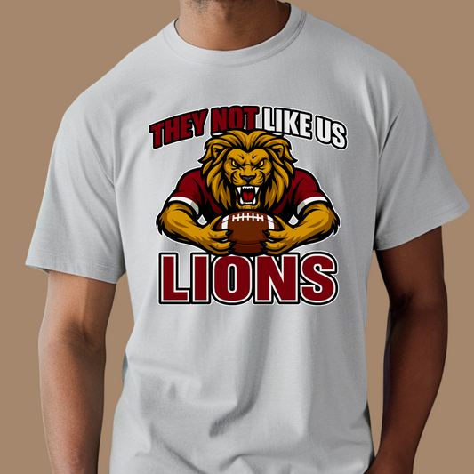 T-shirt with a lion graphic and text on a brown background Custom Mascot Shirt - Lions They Not Like Us Game Day Spirit Tee
