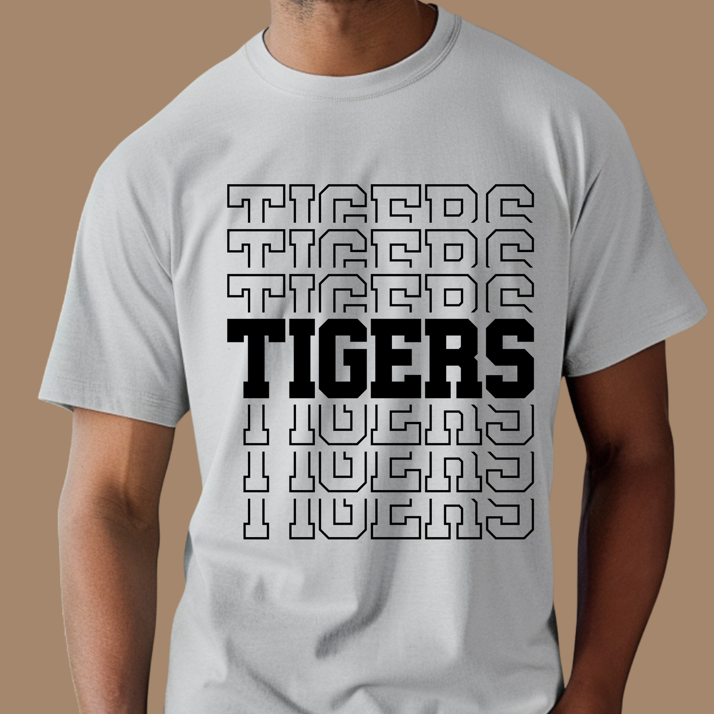 Gray t-shirt with 'Tigers' text design on a brown background, Custom Mascot Shirt - Tigers Pride Game Day Cool School Spirit Tee