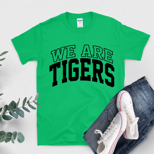 Green t-shirt with 'WE ARE TIGERS' text, white sneakers, and jeans on a light gray background Custom Mascot Shirt - We Are Tigers Game Day Spirit Wear