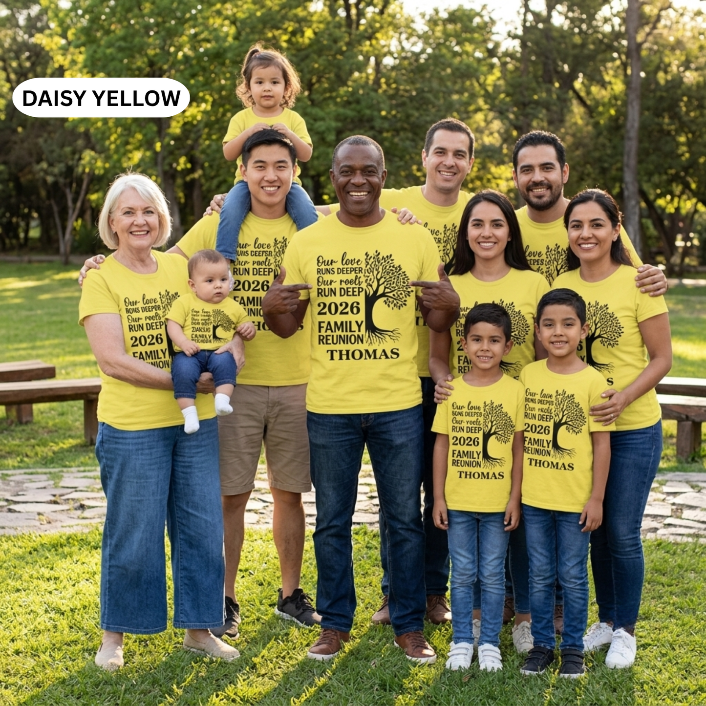 Family wearing matching yellow t-shirts with a tree design and text in a park.