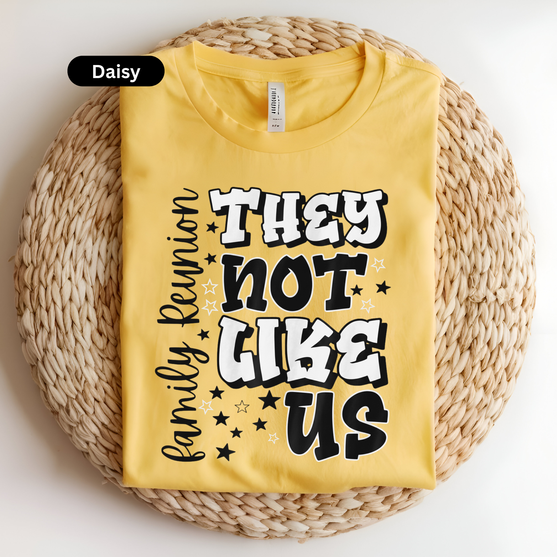 Yellow t-shirt with text on a woven surface