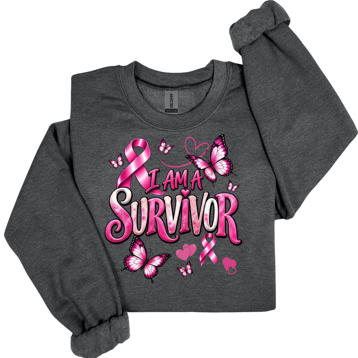 A dark heather gray long-sleeve sweatshirt featuring a pink and white graphic print that reads 'I AM A SURVIVOR' with pink awareness ribbons, butterflies, and hearts, shown on a plain white background.