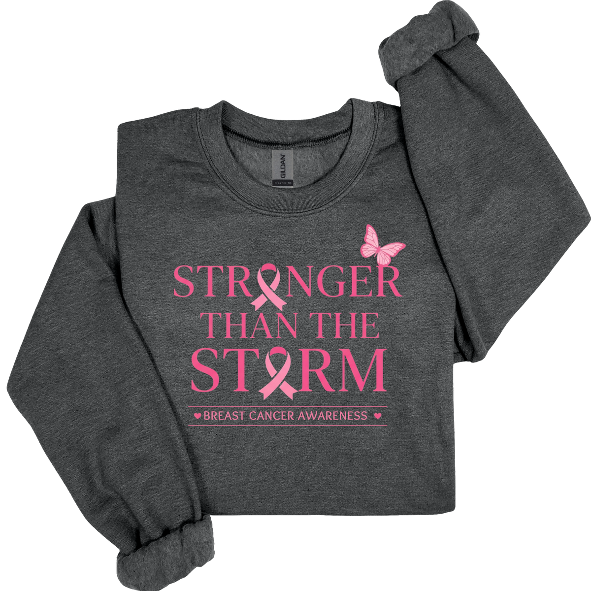 A dark heather gray long-sleeve sweatshirt with rolled cuffs, featuring a pink graphic that reads 'STRONGER THAN THE STORM' with pink ribbons and a butterfly, plus 'BREAST CANCER AWARENESS' at the bottom.