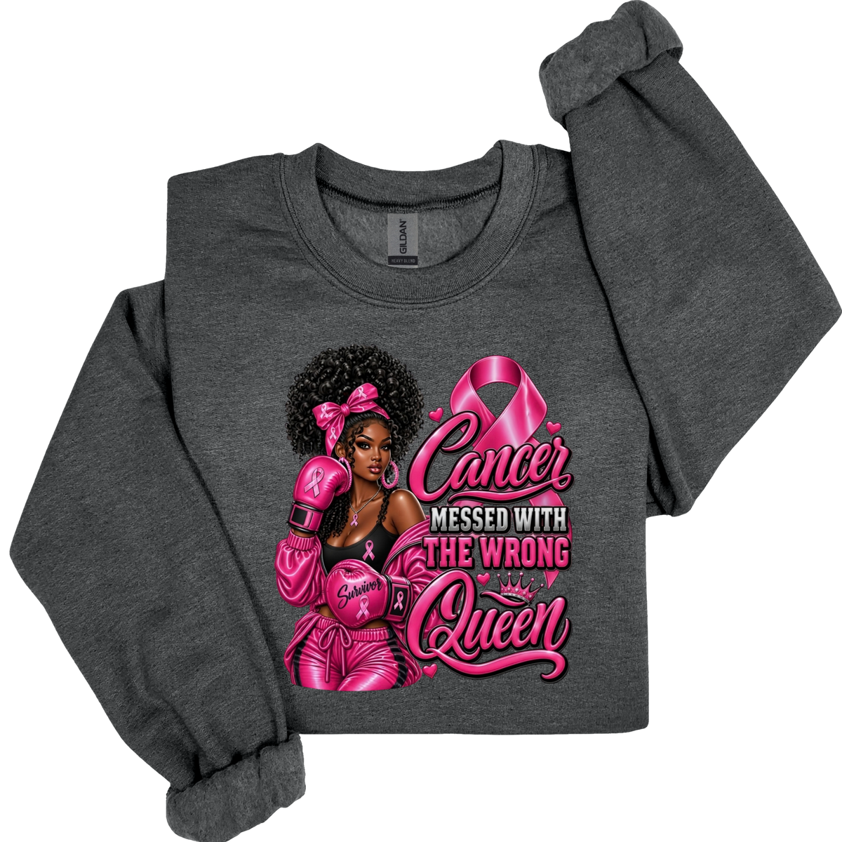 A dark heather gray long-sleeve crewneck sweatshirt featuring a graphic print of a boxer wearing pink boxing gear and a pink ribbon, with the text 'Cancer Messed With The Wrong Queen'.
