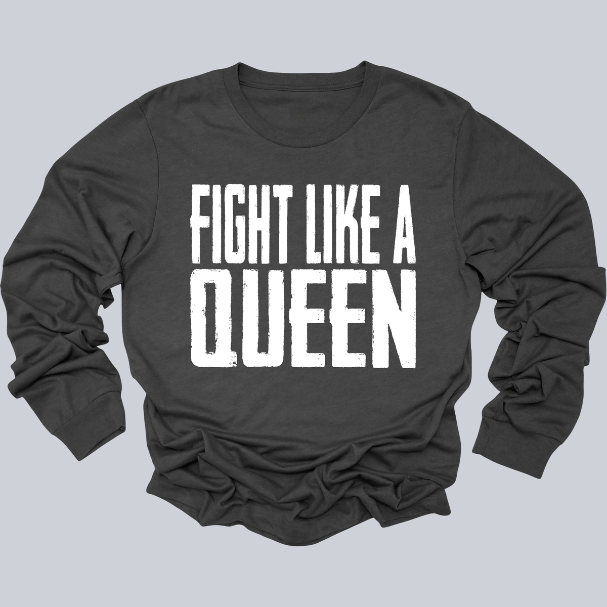 A dark charcoal gray long-sleeve t-shirt with the phrase 'FIGHT LIKE A QUEEN' printed in bold white distressed block letters across the chest, displayed flat against a solid light gray background.