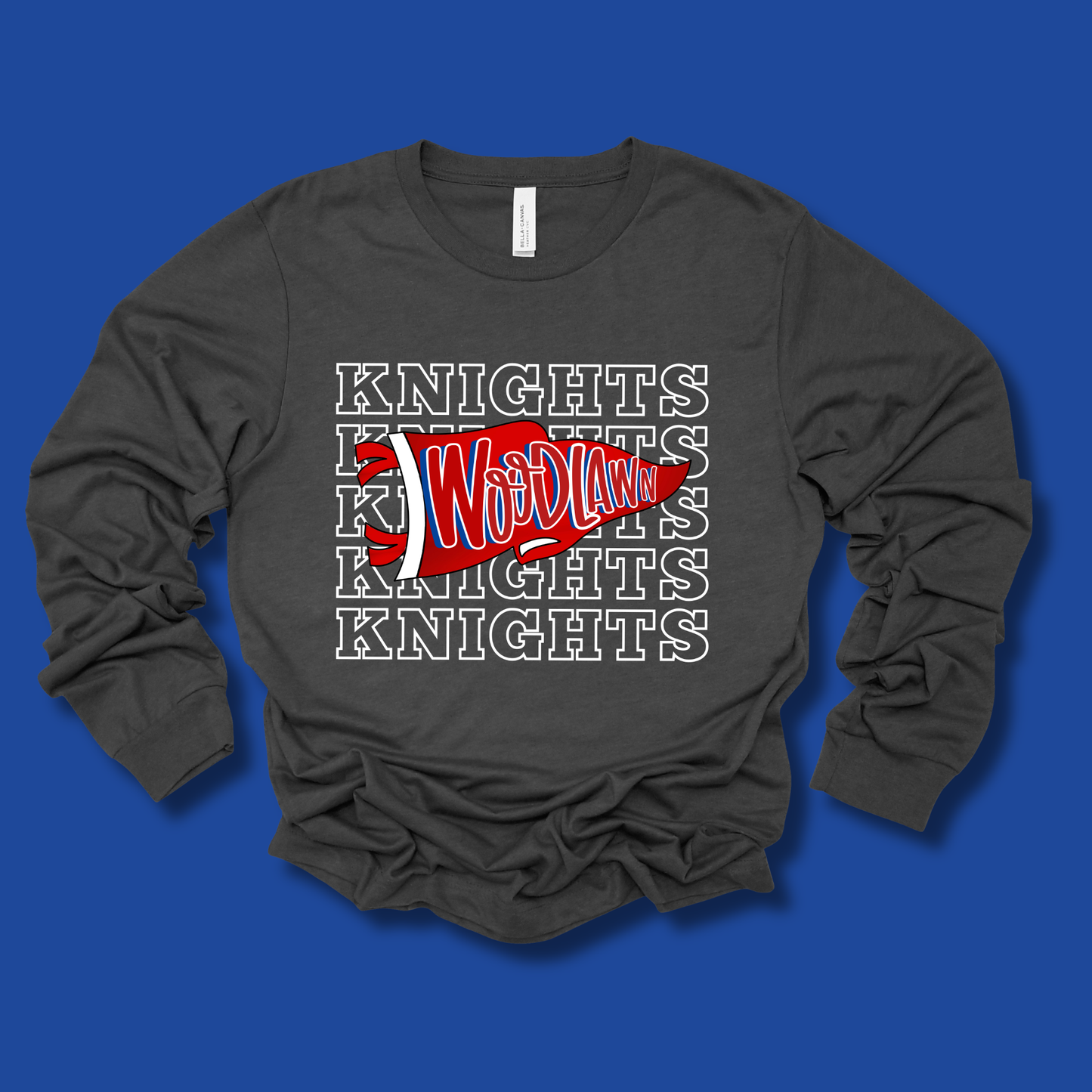 A dark gray long-sleeve t-shirt with a 'Knights Woodland' graphic print, laid flat on a solid blue background.