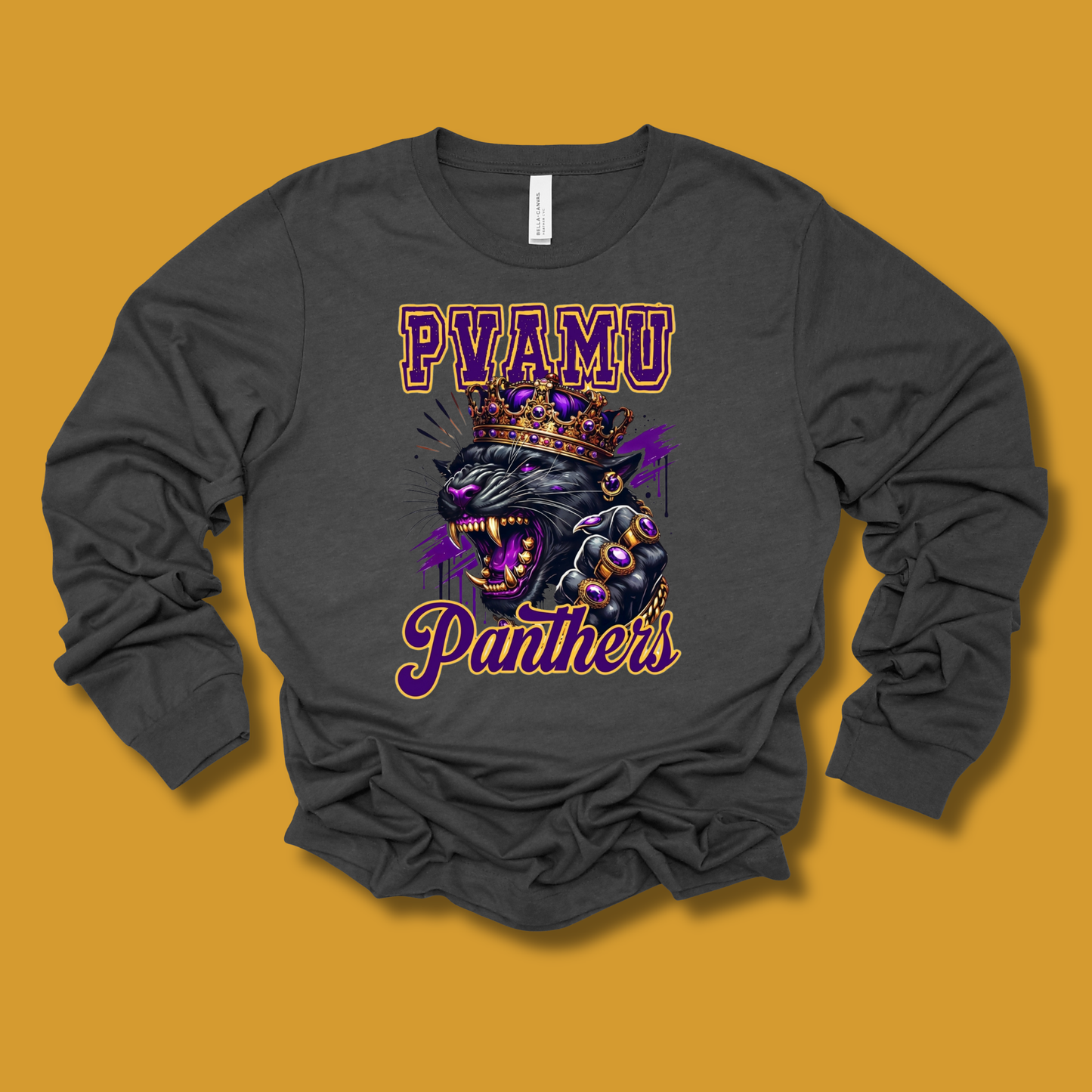 A dark gray long-sleeve t-shirt with a graphic print of a crowned black panther and the text 'PYAMU Panthers' in purple and gold, displayed on a solid mustard yellow background.