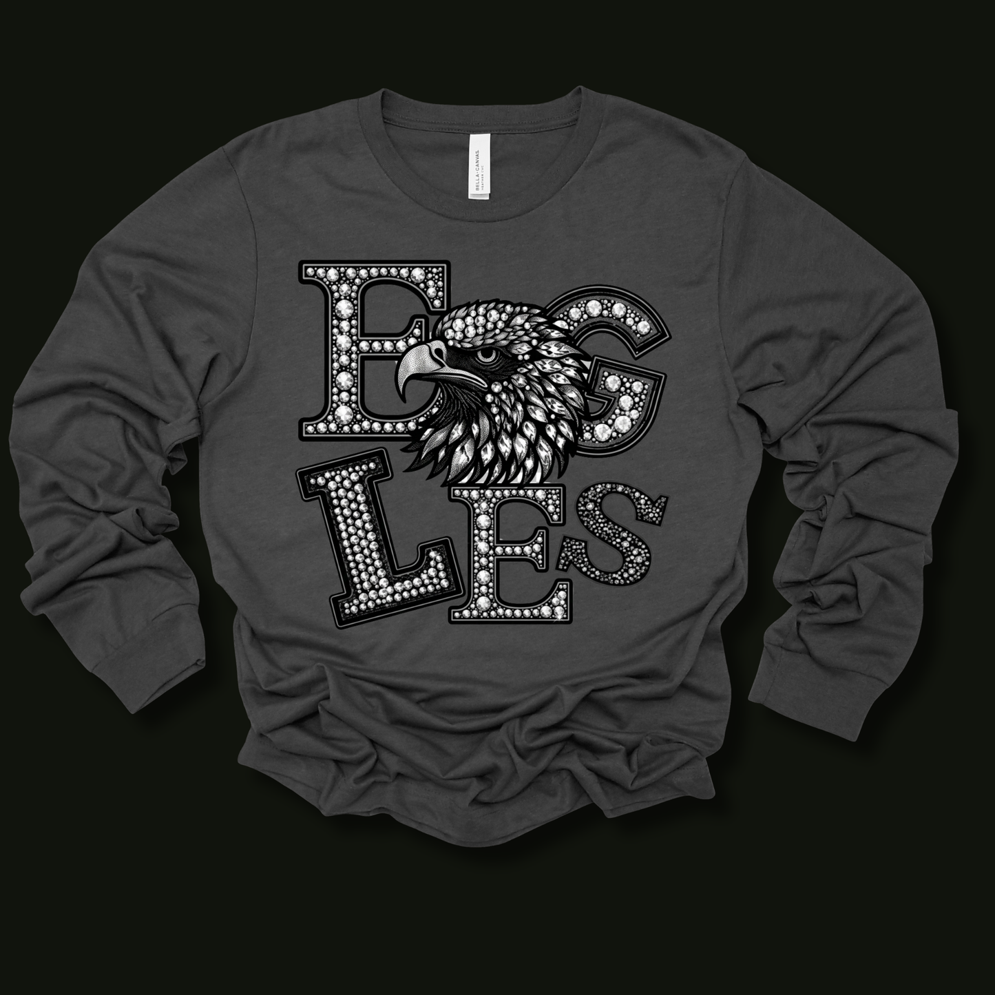 A dark gray long-sleeve t-shirt with a graphic print of an eagle head and the word 'Eagles' in a dotted collegiate font, displayed against a solid black background.
