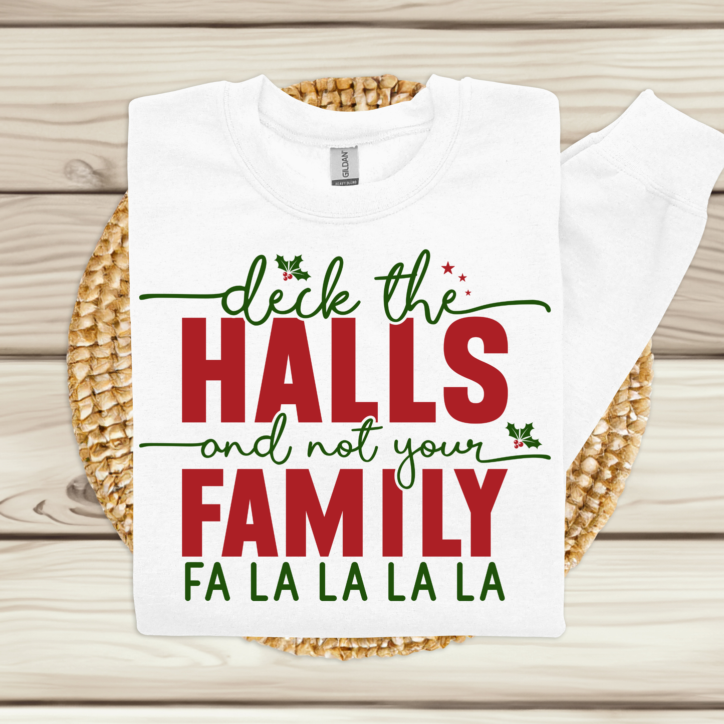 White t-shirt with Christmas-themed text on a wooden surface