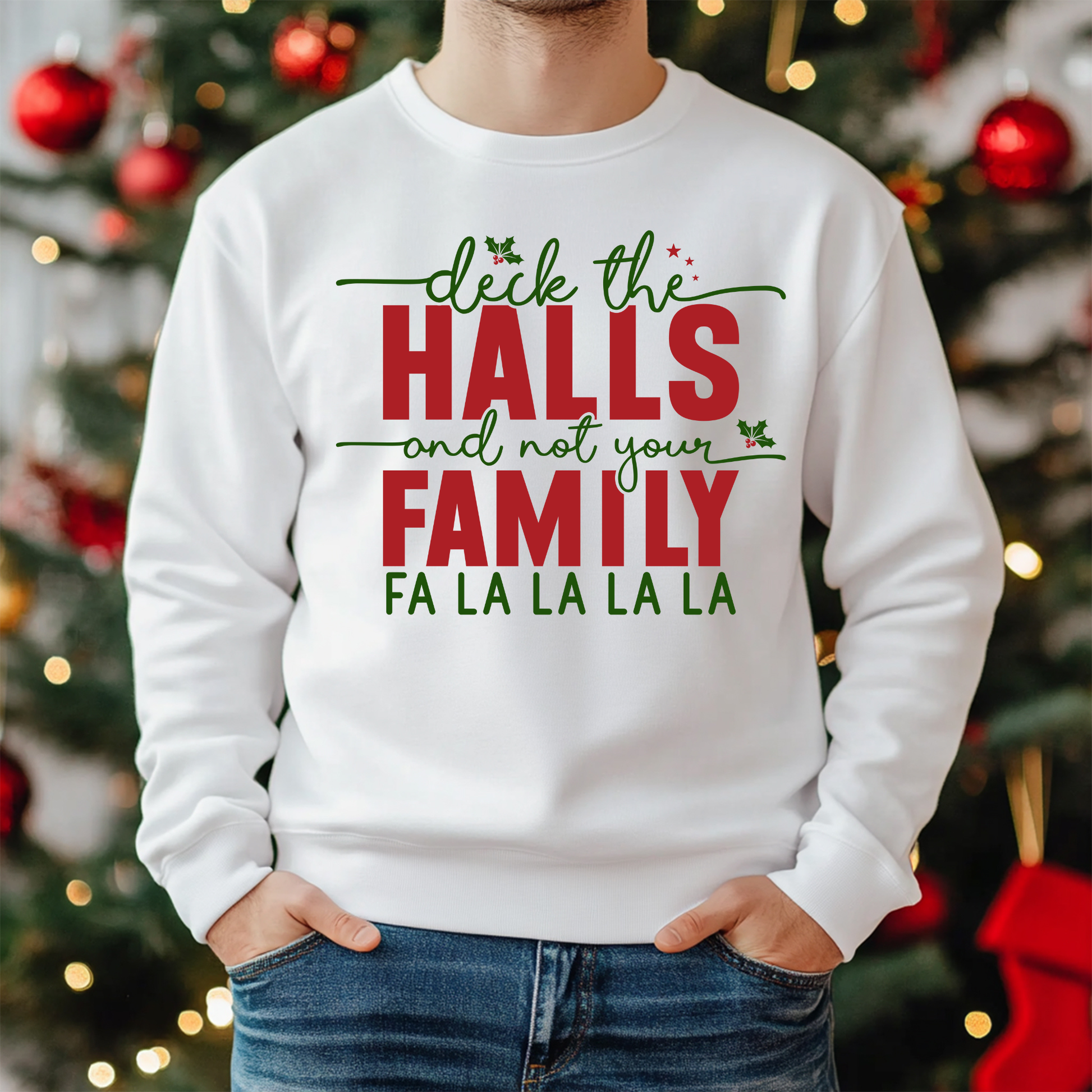 White sweatshirt with Christmas-themed text in front of a decorated Christmas tree.