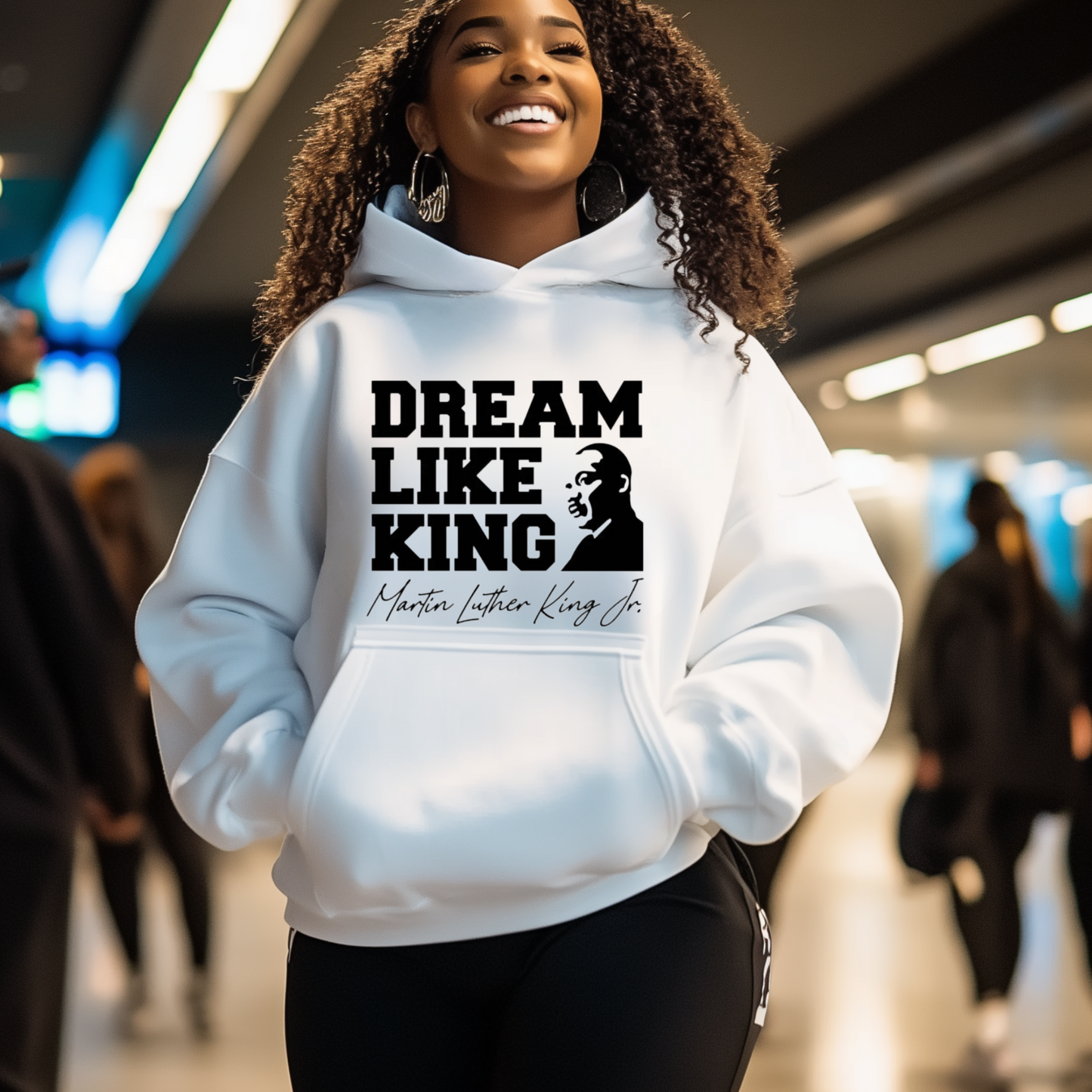 black women wearing a white hoodie with the phrase "DREAM LIKE KING" and an image of Martin Luther King Jr., celebrating Black heritage and empowerment.