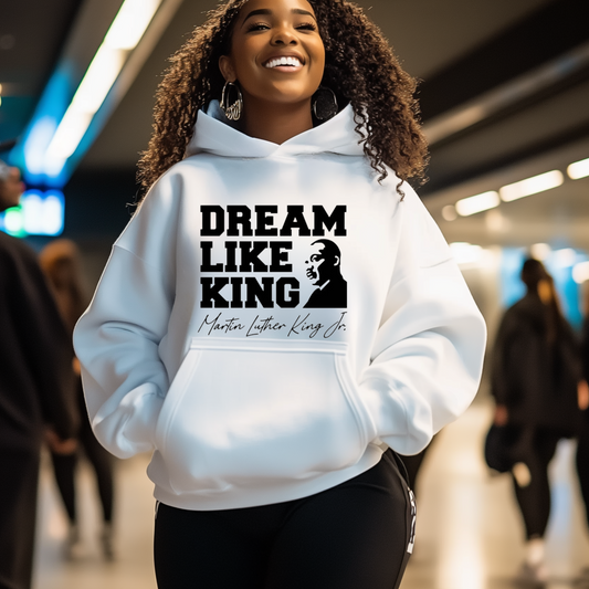 black women wearing a white hoodie with the phrase "DREAM LIKE KING" and an image of Martin Luther King Jr., celebrating Black heritage and empowerment.