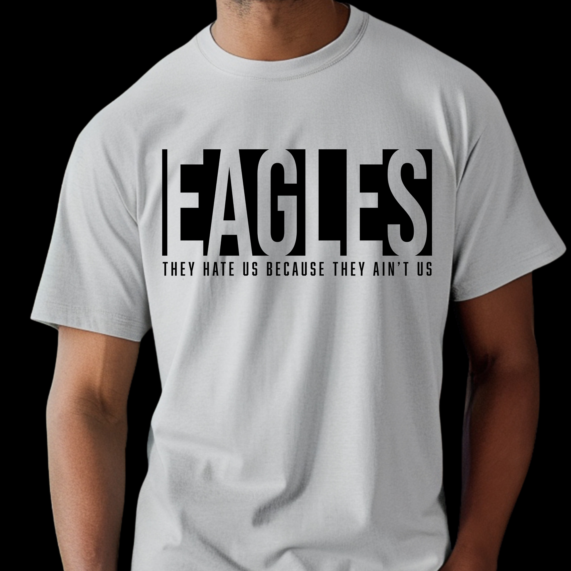 White t-shirt with 'EAGLES THEY HATE US BECAUSE THEY AIN'T US' text on a black background Eagles School Mascot Shirt - Eagles Game Day Cool School Spirit Tee