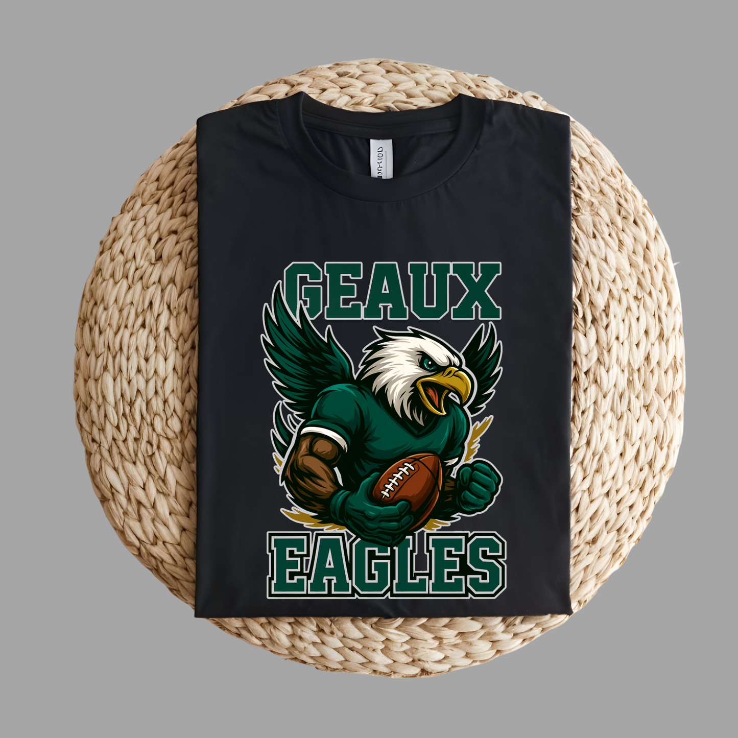 Black t-shirt with an eagle graphic and 'GEAUX EAGLES' text on a woven surface. Eagles Mascot Shirt - Geaux Eagles Game Day Team Spirit Shirt