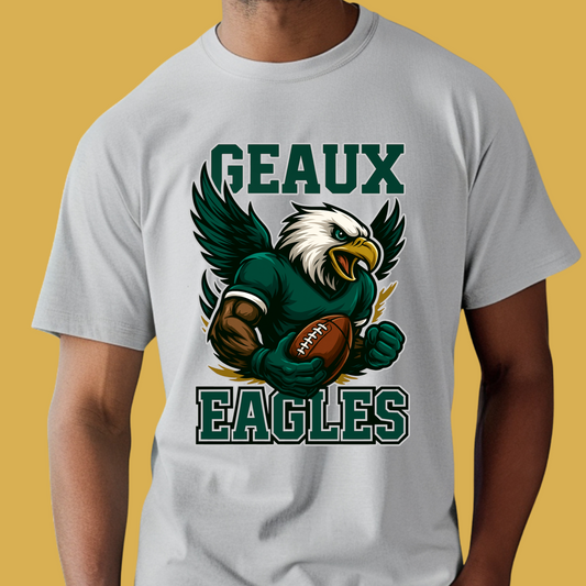 Person wearing a white t-shirt with an eagle graphic and 'GEAUX EAGLES' text on a yellow background Eagles Mascot Shirt - Geaux Eagles Game Day Team Spirit Shirt