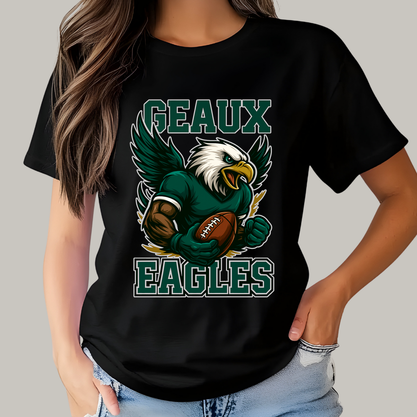 Person wearing a black t-shirt with an eagle graphic and 'GEAUX EAGLES' text. Eagles Mascot Shirt - Geaux Eagles Game Day Team Spirit Shirt