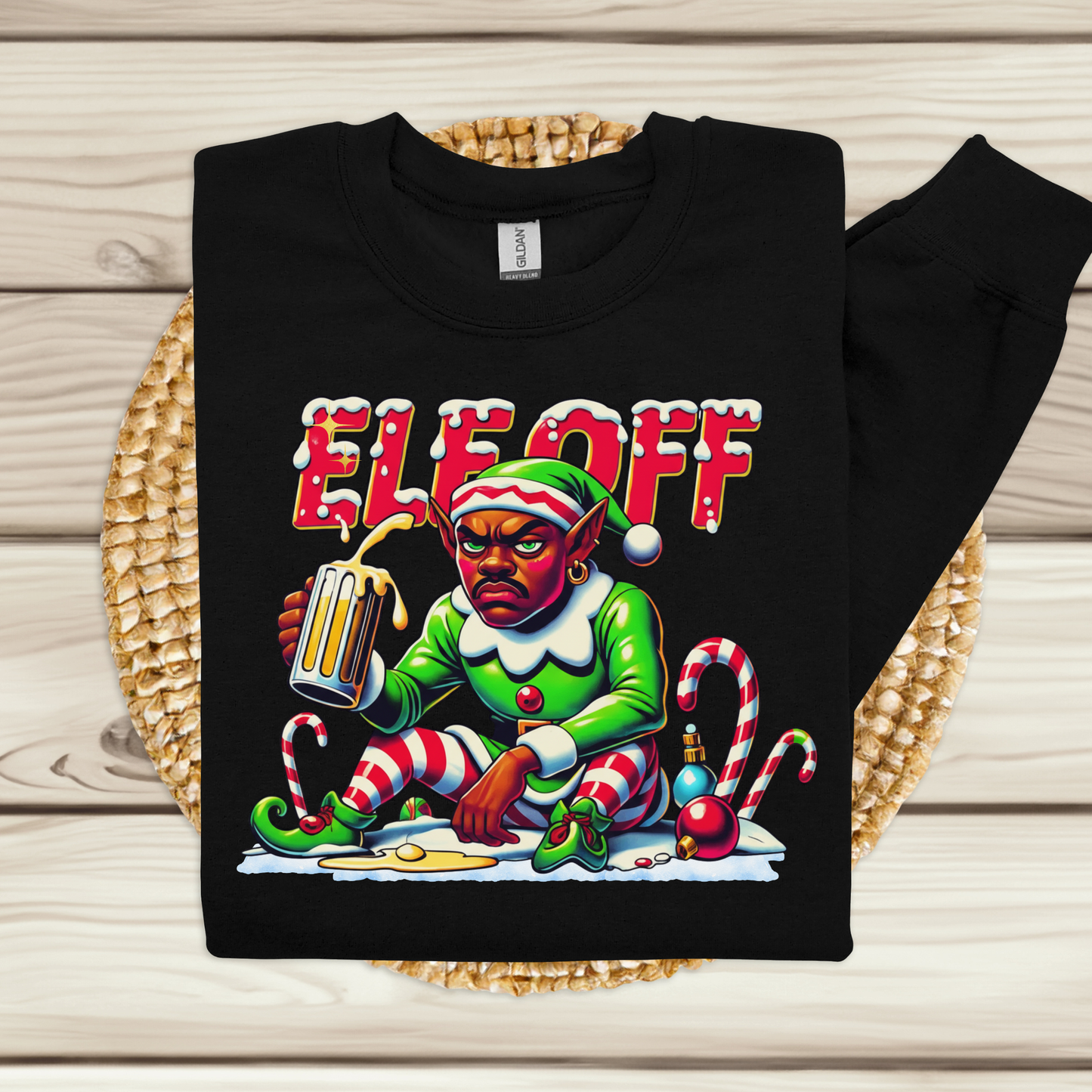 Black sweatshirt with an elf graphic and 'ELE OFF' text on a wooden surface