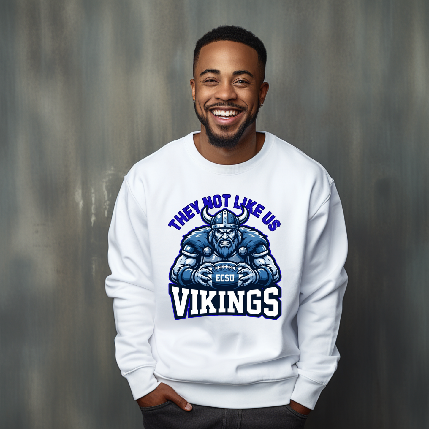 A smiling man wearing a white crewneck sweatshirt with a blue and white graphic of a Viking football player and the text 'THEY NOT LIKE US VIKINGS' and 'EST. 2025'.
