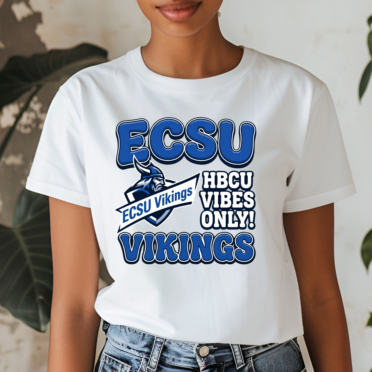 A white short-sleeve graphic T-shirt worn by a model, featuring blue and navy text that reads 'ECSU', 'HBCU VIBES ONLY!', and 'VIKINGS' with a Viking mascot logo.