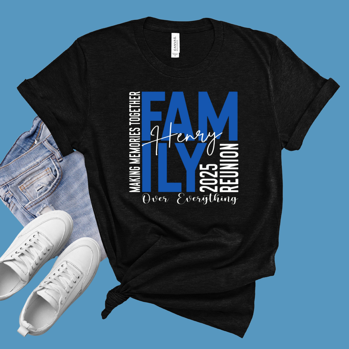 Black t-shirt with family reunion text, white sneakers, and denim jacket on a blue background