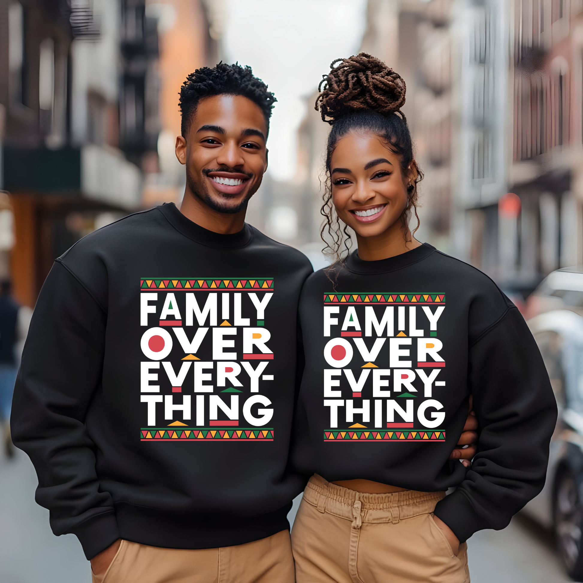Two people wearing black sweatshirts with 'Family Over Everything' text on a city street.