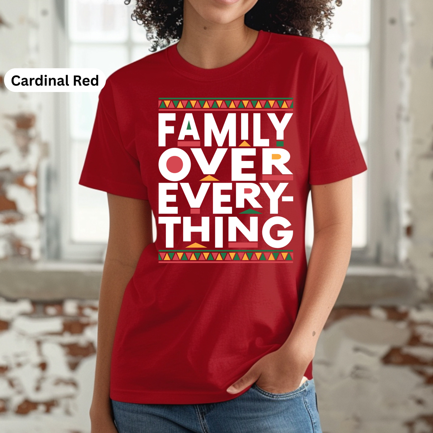 Person wearing a red t-shirt with 'Family Over Everything' text in a festive design.