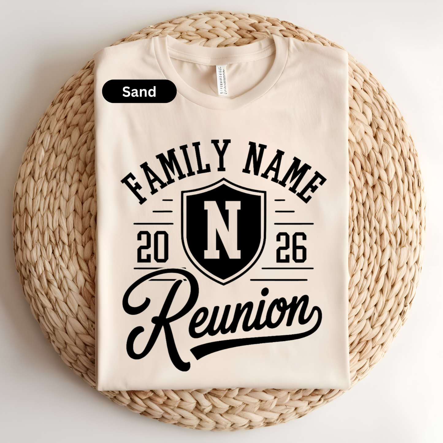 Beige t-shirt with 'Family Name Reunion' design on a woven mat