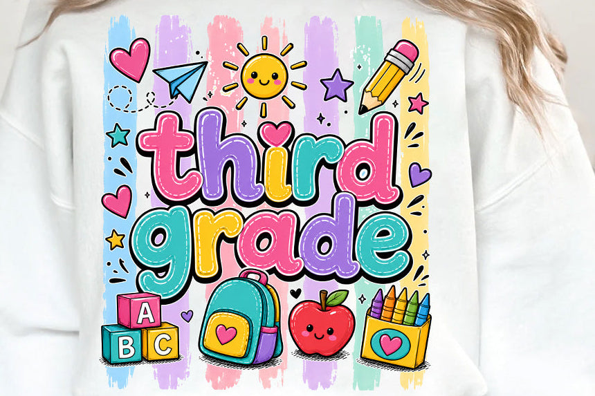 A white crewneck sweatshirt featuring a colorful 'third grade' graphic with school-themed illustrations like a backpack, apple, pencil, and blocks, shown on a model.