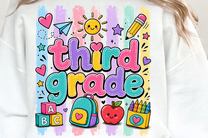 A white crewneck sweatshirt featuring a colorful 'third grade' graphic with school-themed illustrations like a backpack, apple, pencil, and blocks, shown on a model.