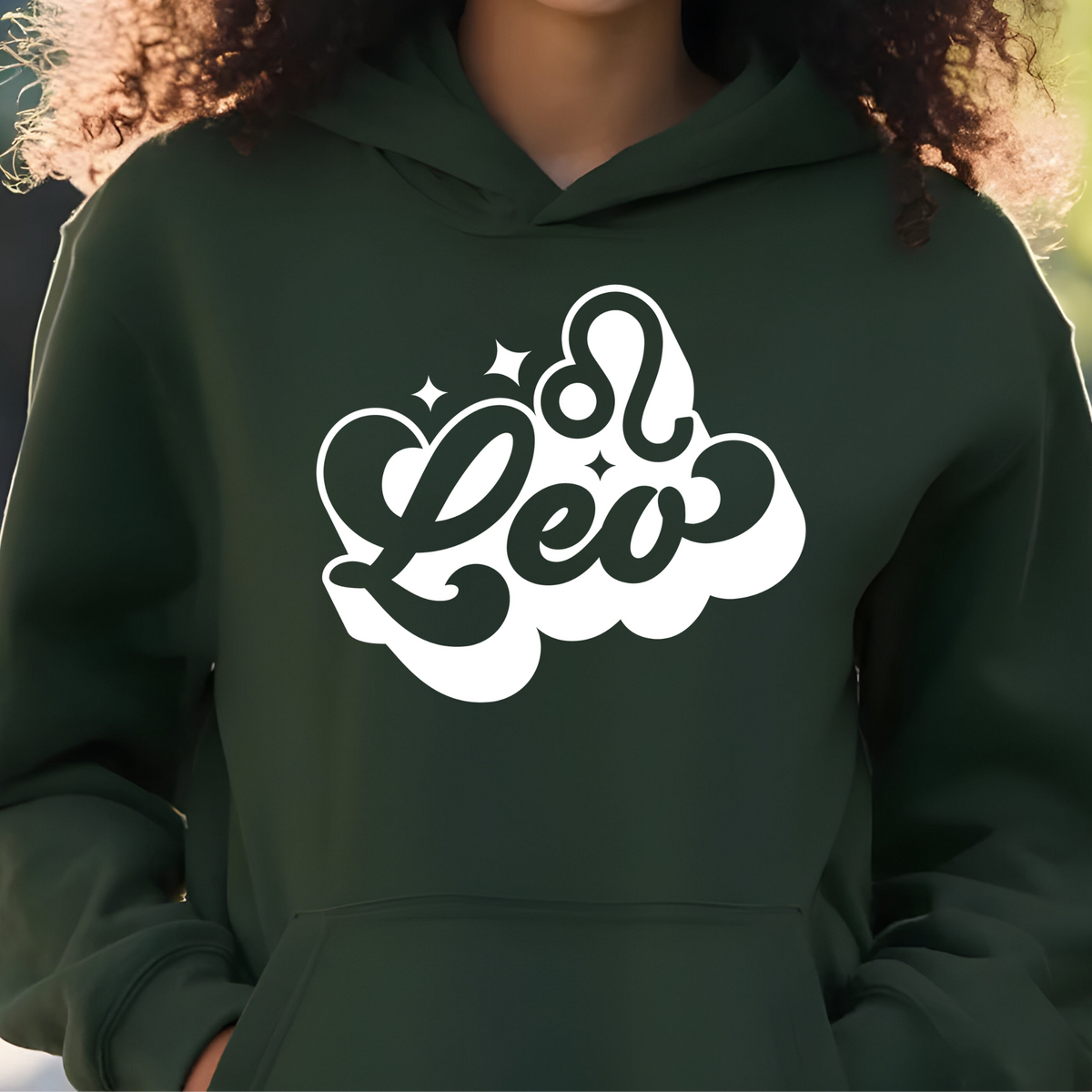 A person wearing a dark forest green hoodie with a stylized white graphic on the chest that reads 'Leo' in a cloud-like outline with small star accents.