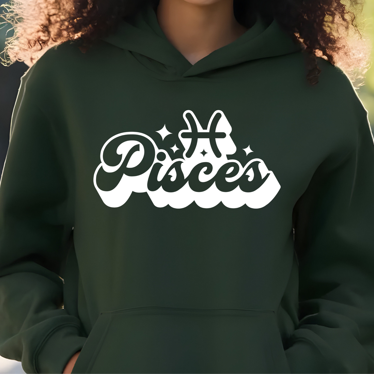 A person wearing a dark forest green hoodie with a white graphic print that reads 'Taurus' in stylized script and includes a Taurus zodiac symbol on the chest.