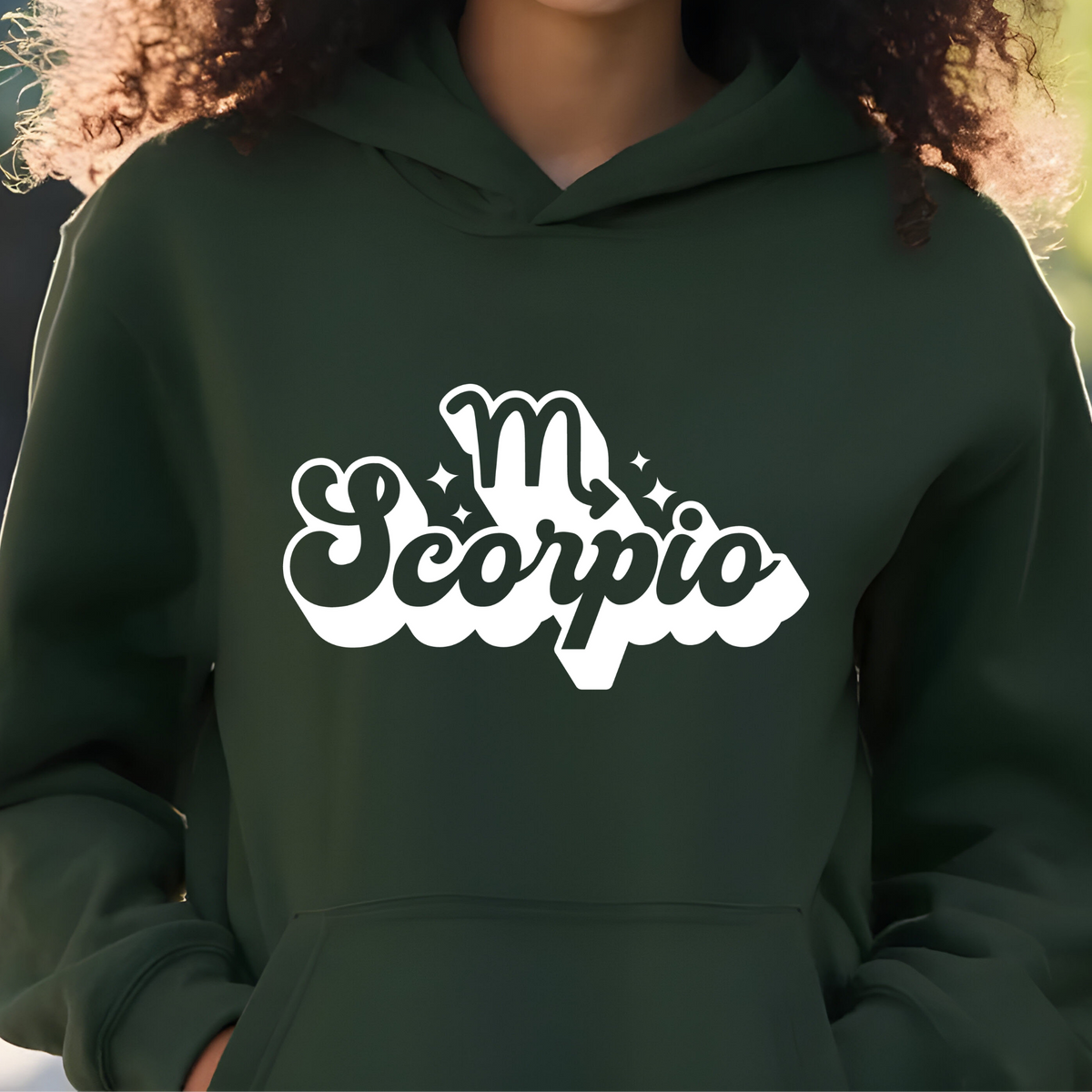 A person wearing a dark forest green hoodie with a white graphic print on the chest that reads 'Taurus' with a Taurus zodiac symbol above it.