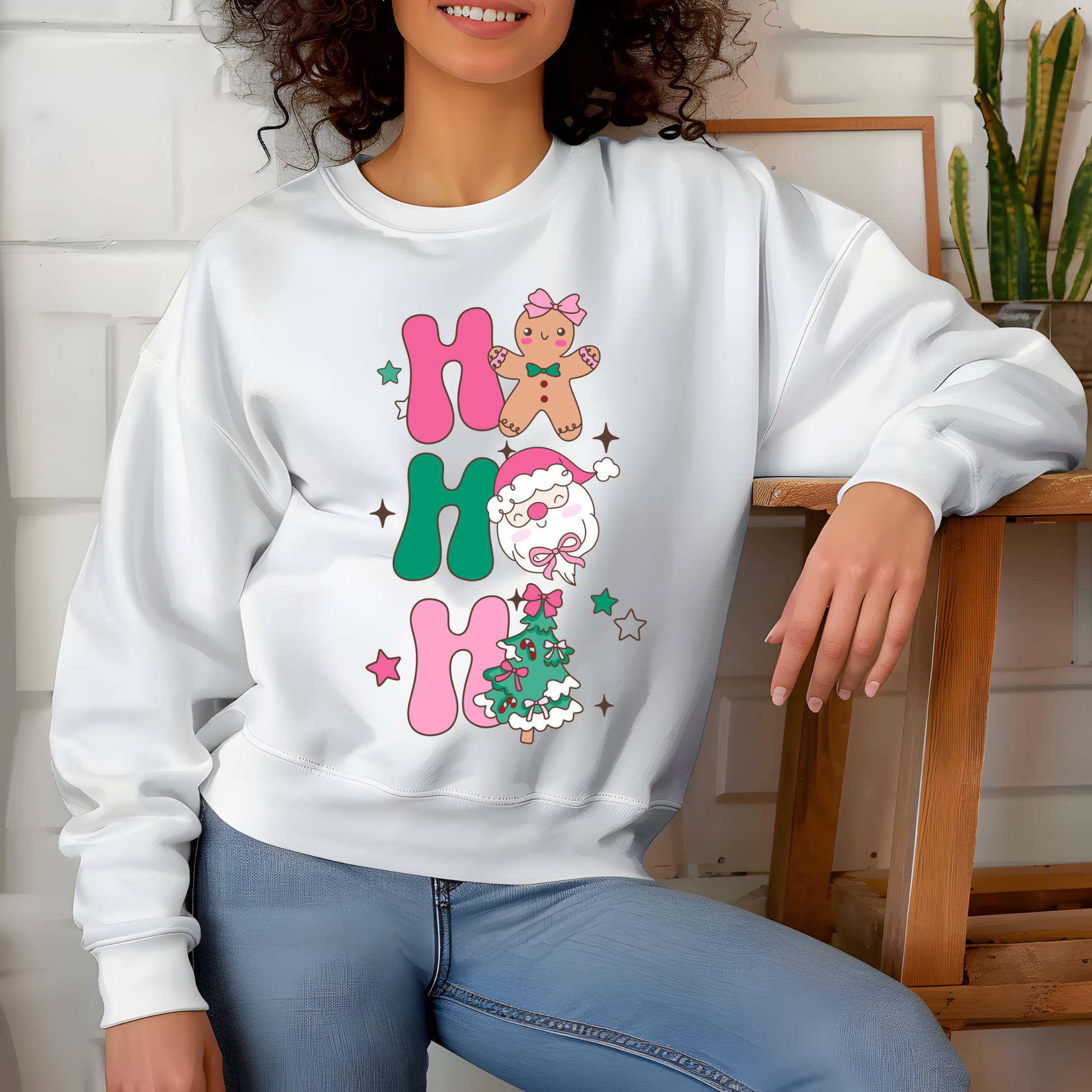 Person wearing a white sweatshirt with Christmas-themed designs and text.