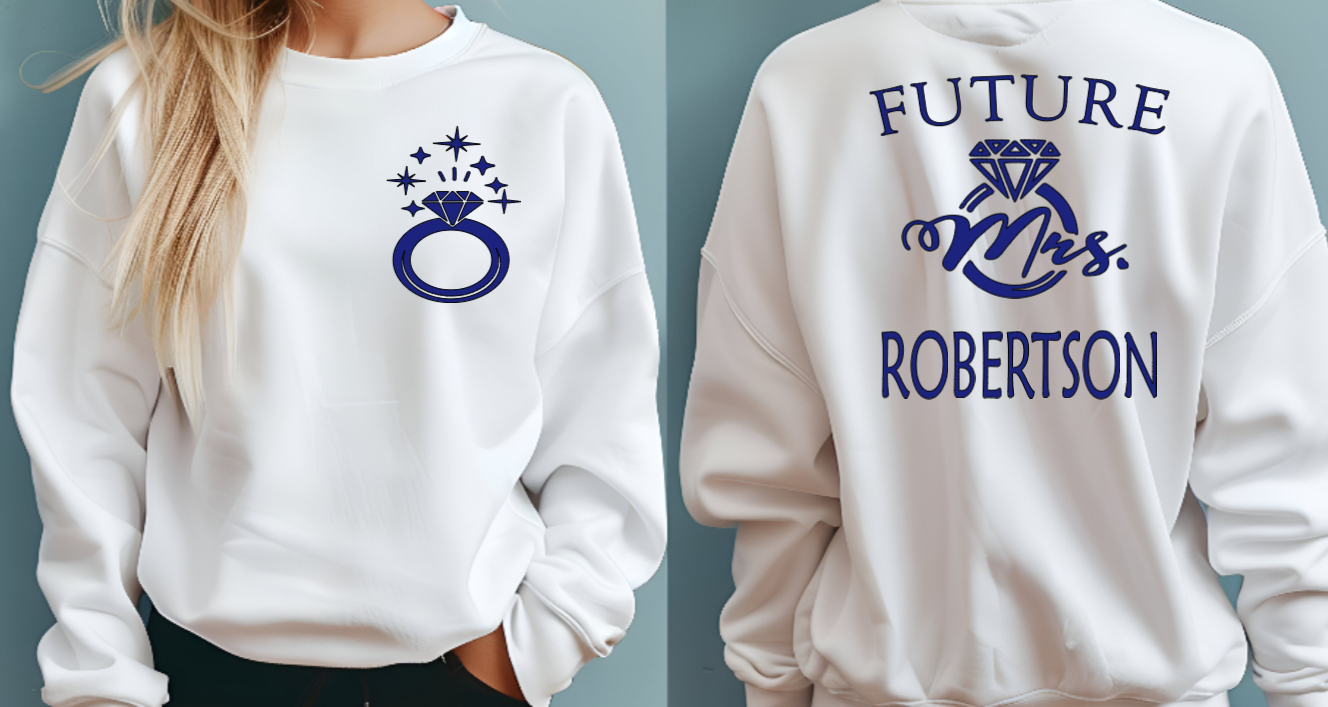 Woman wearing white sweatshirt with FUTURE Mrs. on the back with bling ring on the front indicating engagement announcement shirt for bridal shower or engagement party and gift for new bride to be. 