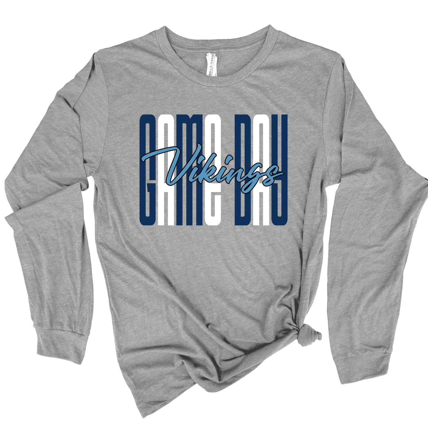A heather gray long-sleeve t-shirt with a 'GAME DAY Vikings' graphic on the chest, styled with a knot at the bottom hem, shown on a plain white background.
