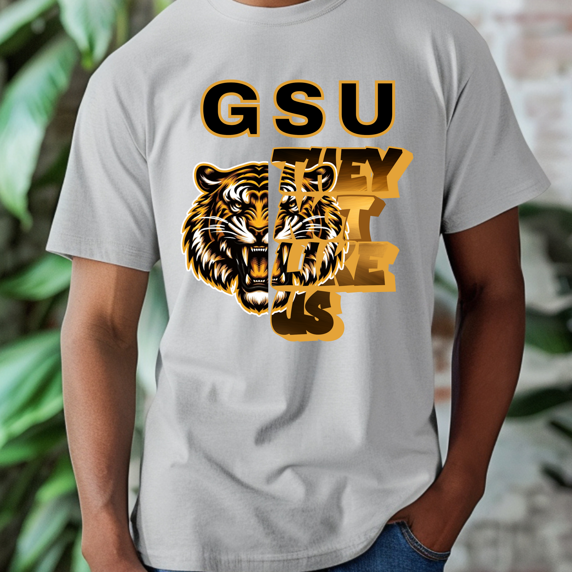 Gray t-shirt with tiger graphic and 'GSU THEY LIKE US' text on a blurred background Grambling State Tigers T-Shirt - They Not Like Us - Game Day Statement Tee