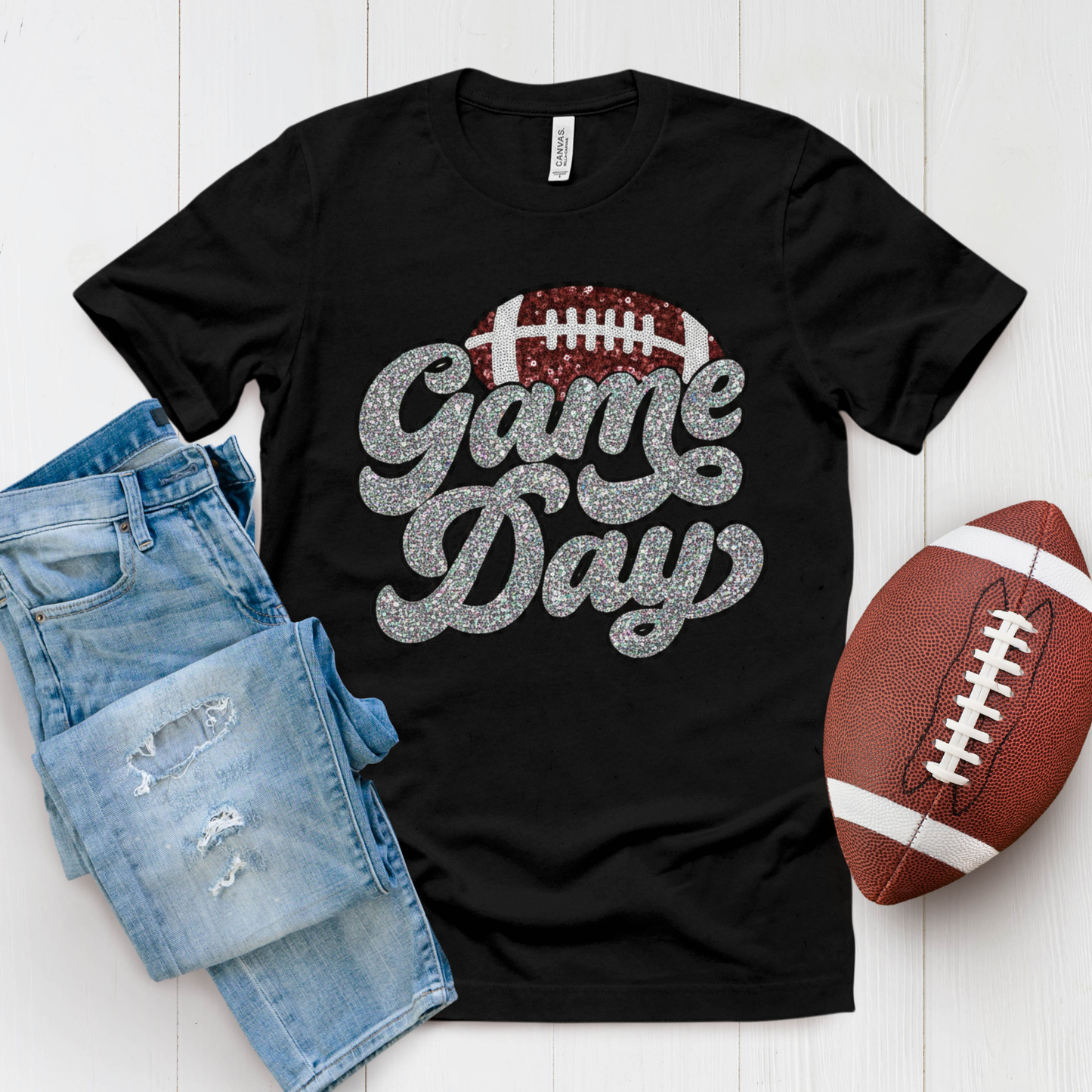 Black t-shirt with 'Game Day' text, denim shorts, and football on a white background