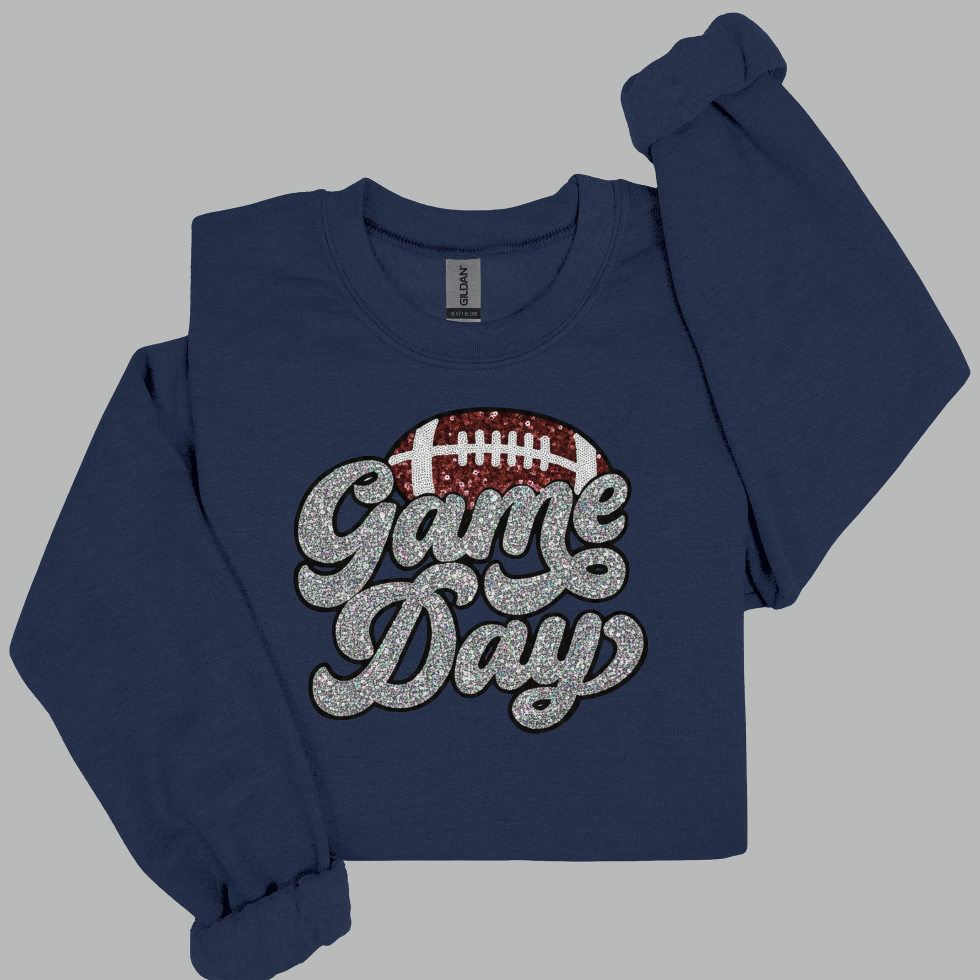 Navy blue sweatshirt with 'Game Day' and football graphic on a gray background