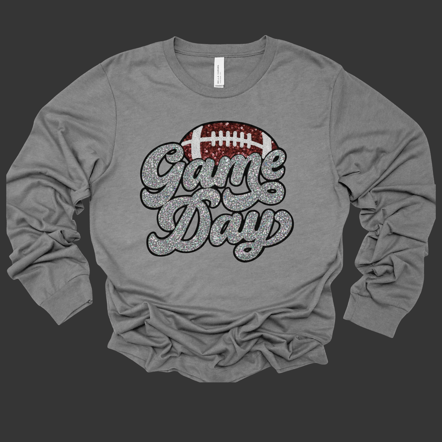 Gray long-sleeve shirt with 'Game Day' and football graphic on a black background