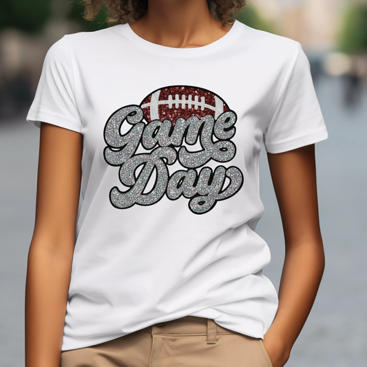 Person wearing a white t-shirt with 'Game Day' and football graphic.