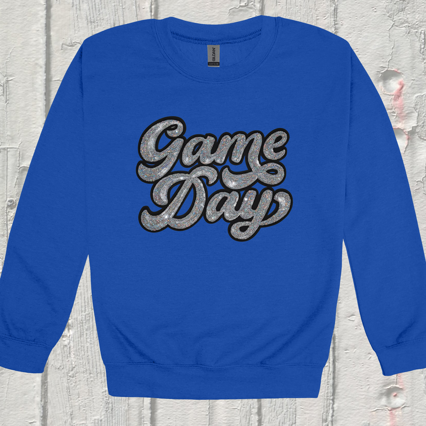 Blue sweatshirt with 'Game Day' text on a textured gray background
