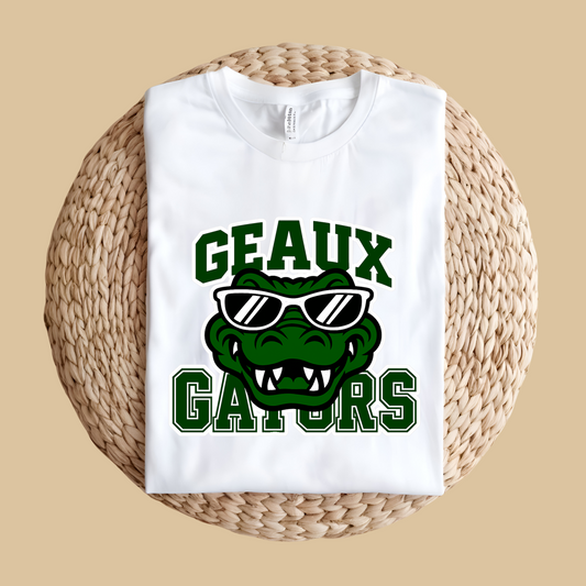 White sweatshirt with 'Geaux Gators' design featuring an alligator wearing sunglasses on a woven surface. Gators Mascot Shirt - Geaux Gators Game Day Mascot Shirt