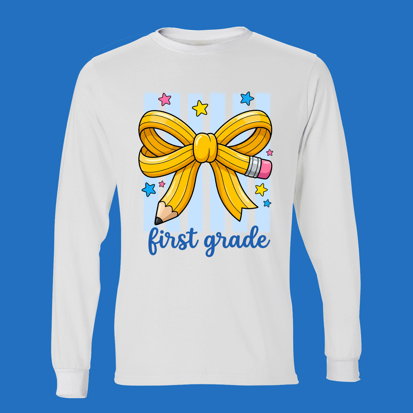 A white long-sleeve crewneck sweatshirt featuring a cartoon graphic of a yellow pencil tied in a bow, colorful stars, and the text 'first grade' in blue script, displayed against a solid blue background.
