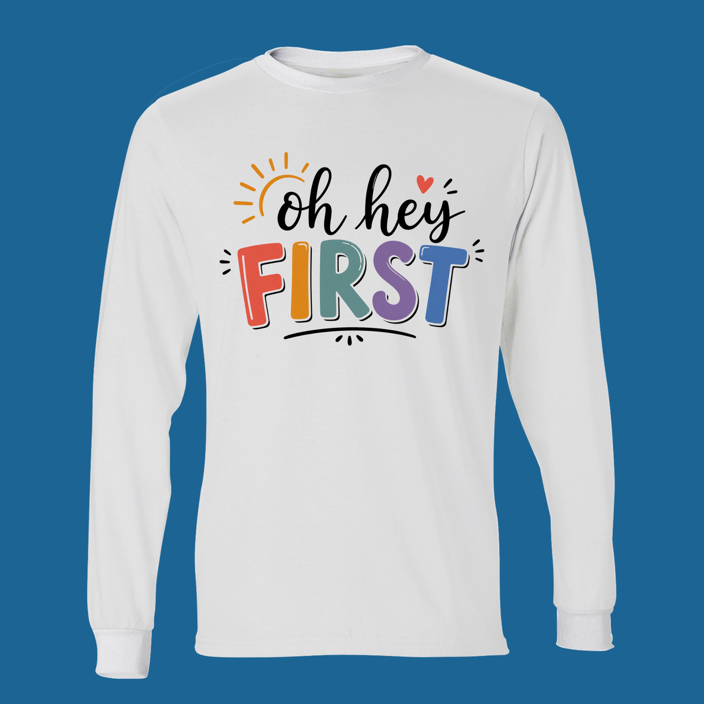 A white long-sleeve t-shirt with a colorful graphic on the chest reading 'Kinder Garten' in a floral pattern, decorated with small gardening icons and a pink ribbon bow underneath, set against a solid blue background.