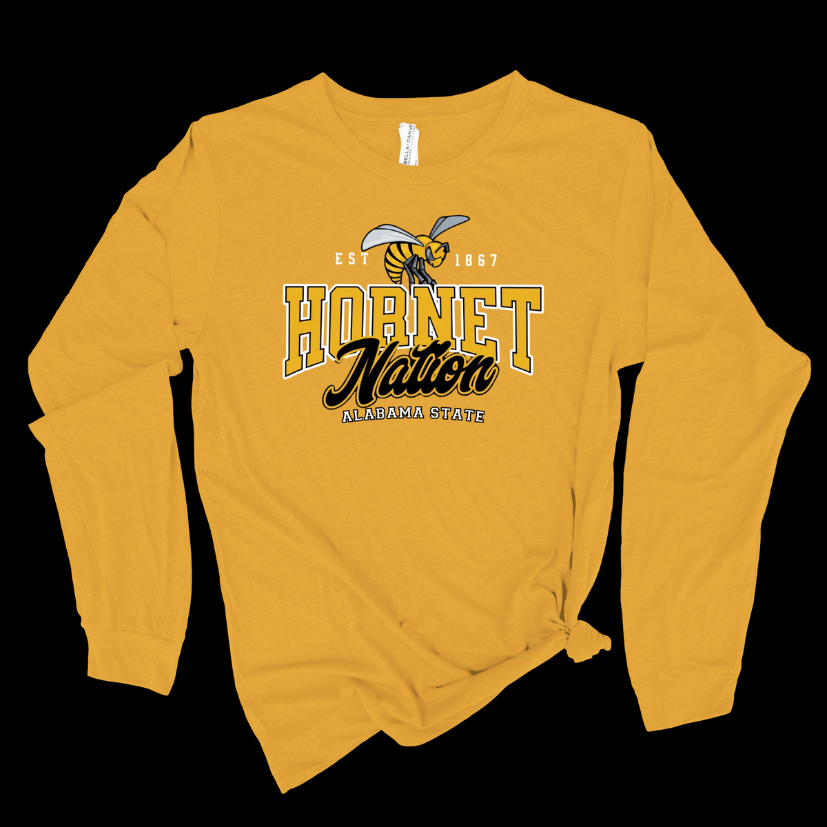 A long-sleeve t-shirt in a golden yellow color, featuring a 'Hornet Nation' graphic with a hornet mascot on the chest. The shirt is styled with a knot at the bottom right hem against a solid black background.