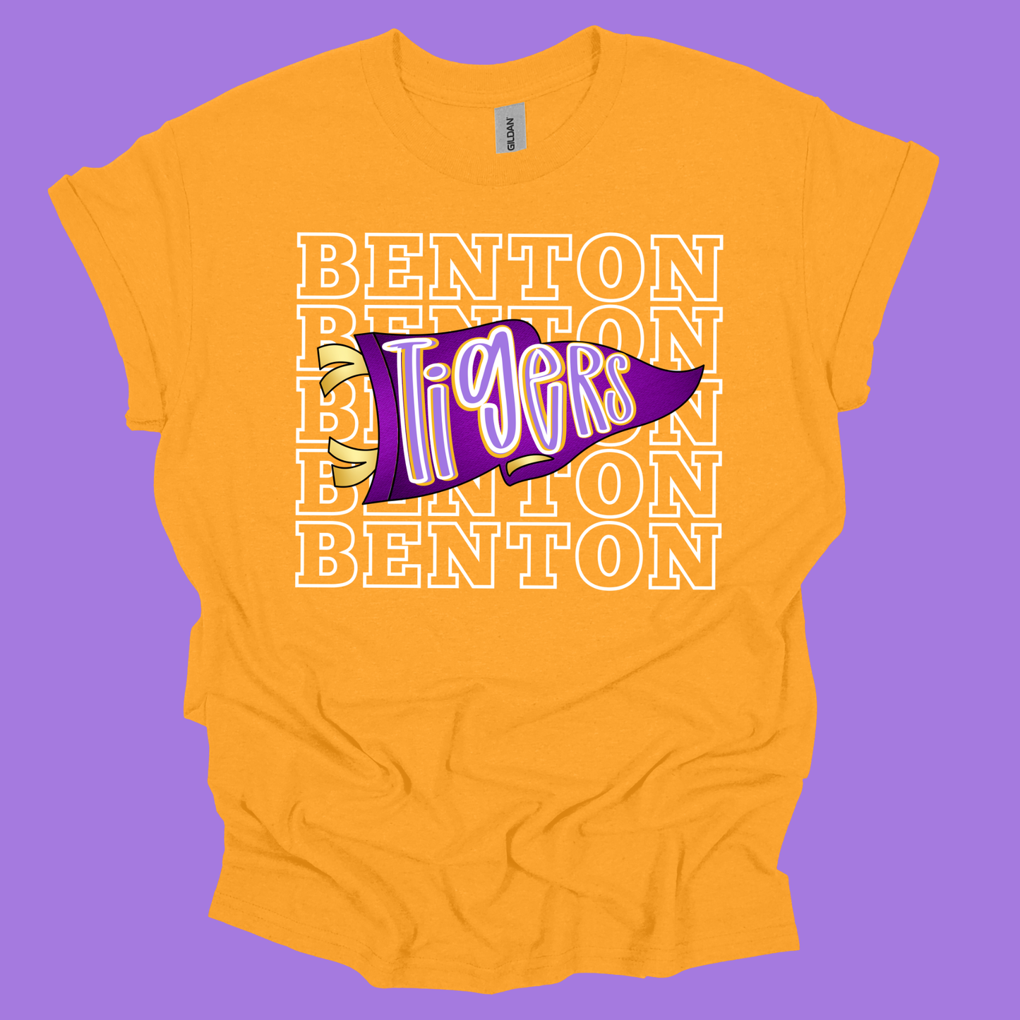 A yellow short-sleeve t-shirt with a purple and white 'Benton Tigers' pennant graphic on the front, set against a solid purple background.