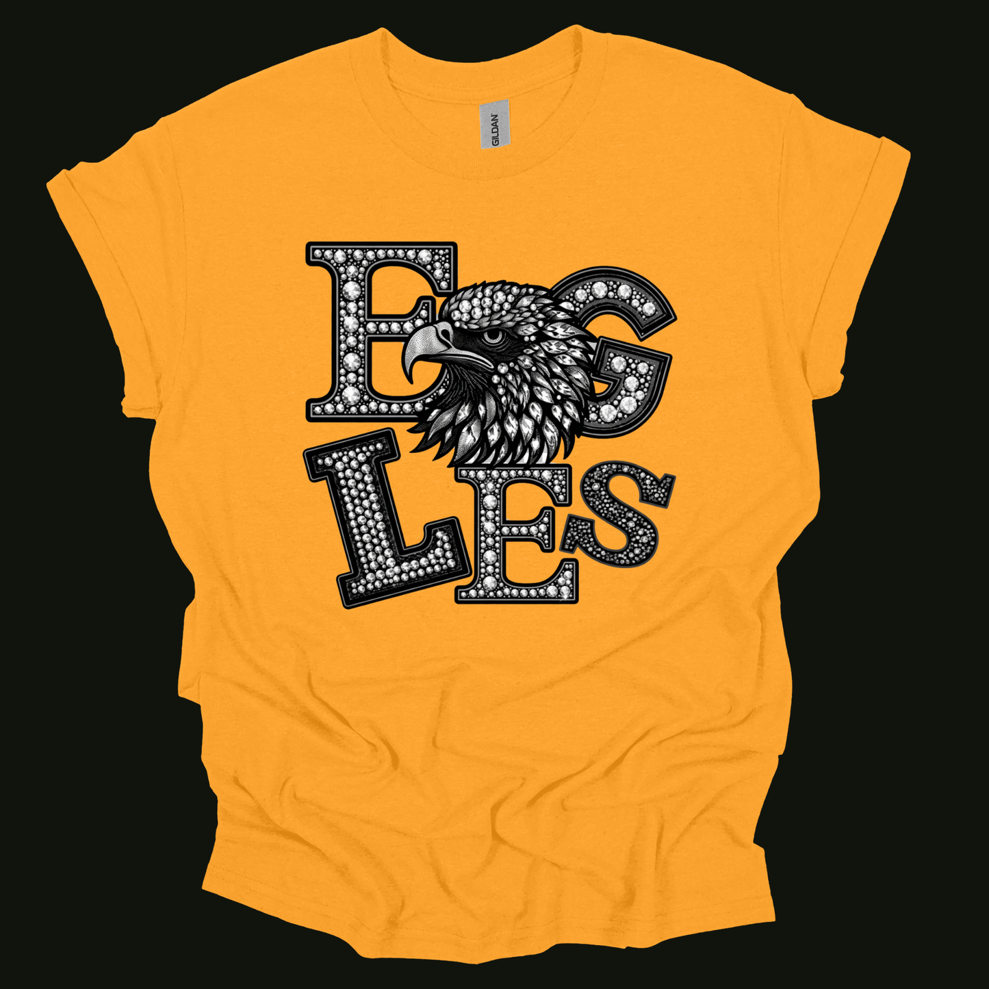 A bright yellow short-sleeve t-shirt with a graphic print of an eagle head and the word 'EAGLES' in a black and white dotted font, displayed flat against a solid black background.