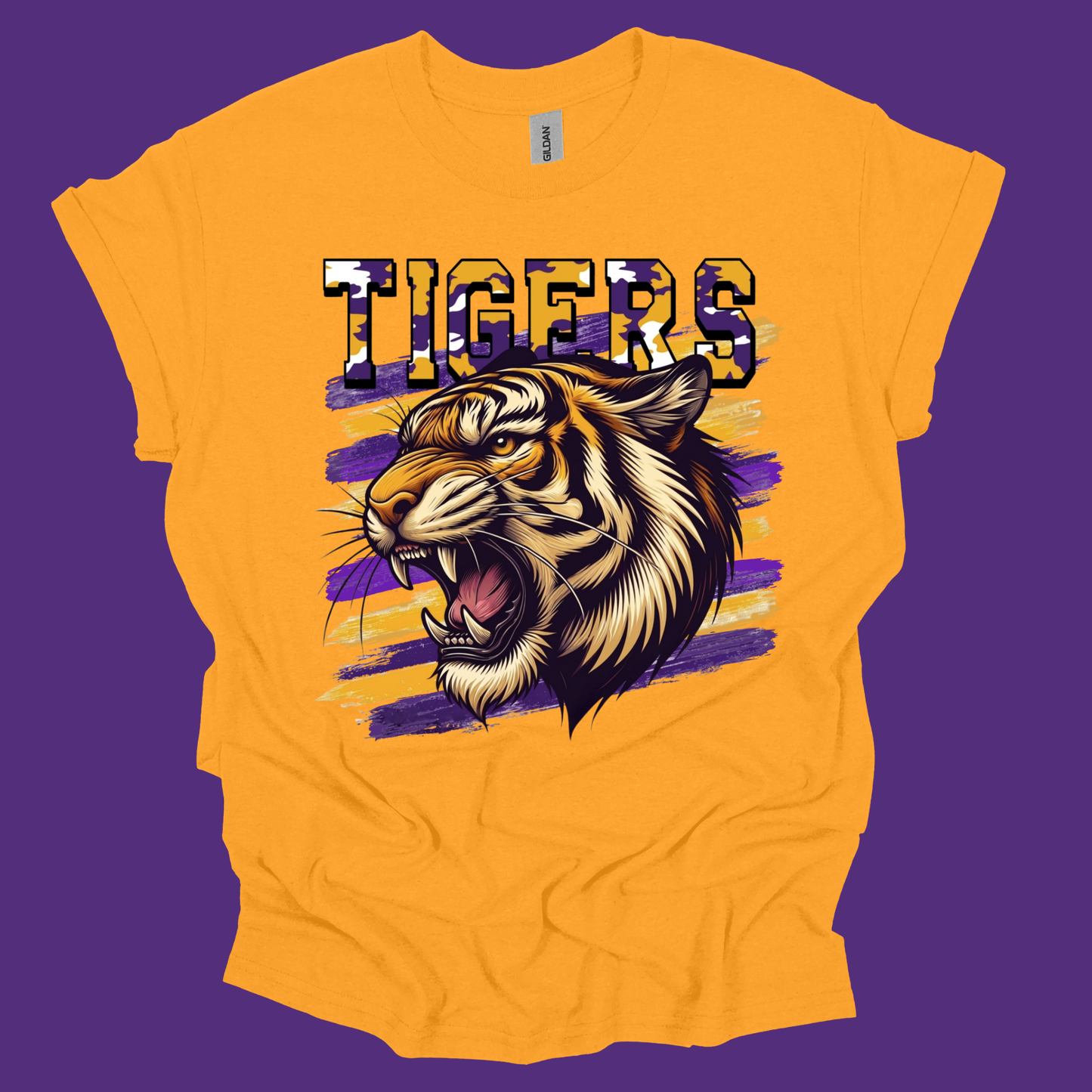 A bright yellow short-sleeve t-shirt with a graphic of a roaring tiger and the word 'TIGERS' in a patterned font, set against a solid purple background.